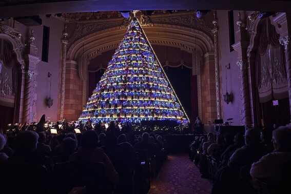 Michigan high school choir belts out holiday tunes from a towering Christmas tree